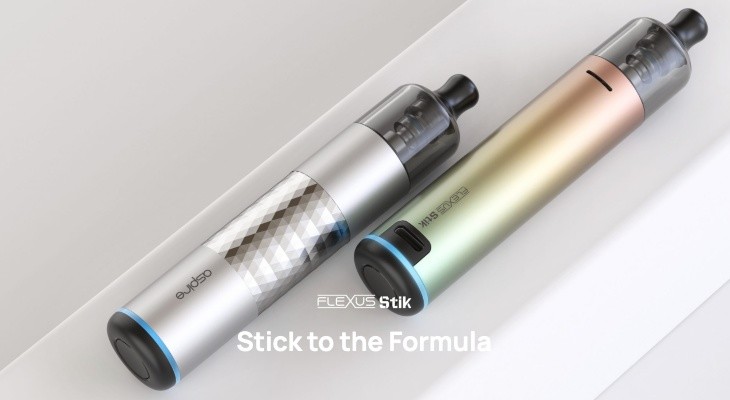 Two Aspire Flexus Stiks are laying on a long white stand in different colourways.